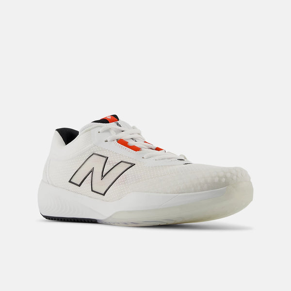 A white New Balance athletic shoe with a black outlined 'N' logo, white laces, and bright orange accents on the tongue and lace loop, shown against a light gray background.