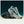 White and green running shoe with black sole on a gradient background