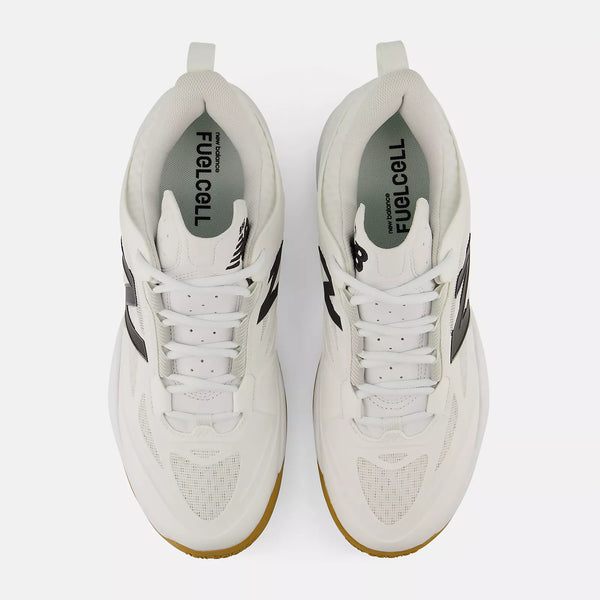 A pair of white New Balance tennis sneakers shown from a top-down view on a light gray background. The shoes feature black side stripes, a white laces, and a gum-colored outsole.