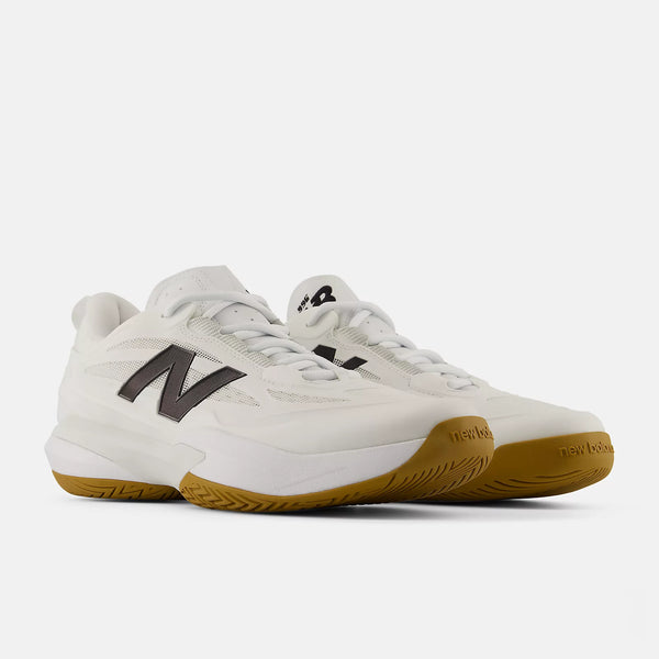 A pair of New Balance tennis sneakers in white with dark gray 'N' logos and gum brown soles, photographed on a clean light gray background.