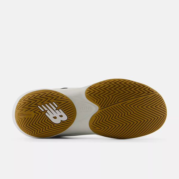 The outsole of a New Balance sneaker, showing a white upper and a brown herringbone-patterned rubber sole with a white New Balance 'NB' logo on the heel.