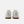 A pair of New Balance court shoes shown from the back, featuring an off-white leather upper and a brown gum sole, set against a light gray background.