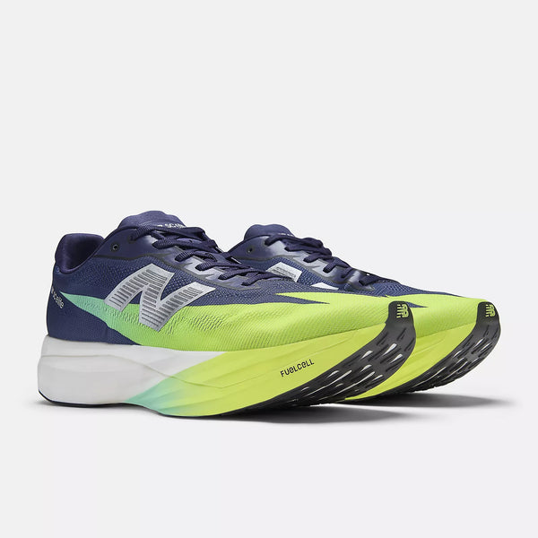 Navy and green running shoe with New Balance logo on a white background