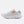 White running shoe with orange logo on a light gray background