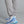 Gray sweatpants with 'Municipal' branding and blue sneakers on a gray background