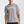 Person wearing a gray t-shirt with 'MUNICIPAL' text on a plain background.