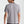 Person wearing a gray t-shirt on a plain background