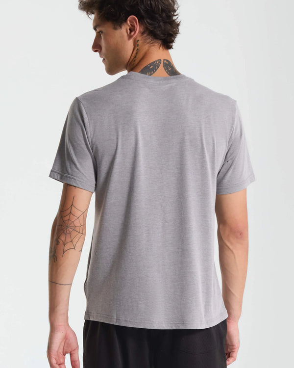 Person wearing a gray t-shirt on a plain background