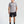 Man wearing a gray 'Municipal' t-shirt and black shorts on a white background