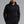 Man wearing a black hoodie with 'MUNICIPAL' text on a gray background