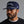 Man wearing a navy blue cap with 'MUNICIPAL' text on a gray background.