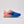 Pink and blue running shoe on a neutral background