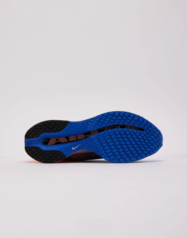 Pink and blue running shoe on a neutral background
