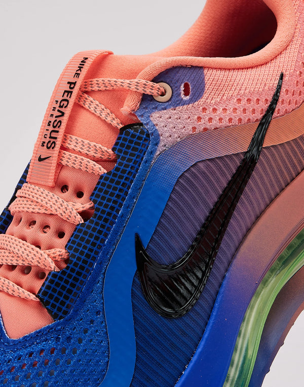 Pink and blue running shoe on a neutral background