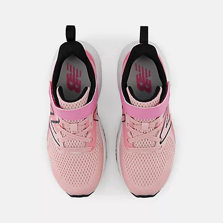Pink, white, and black shoe on a white background
