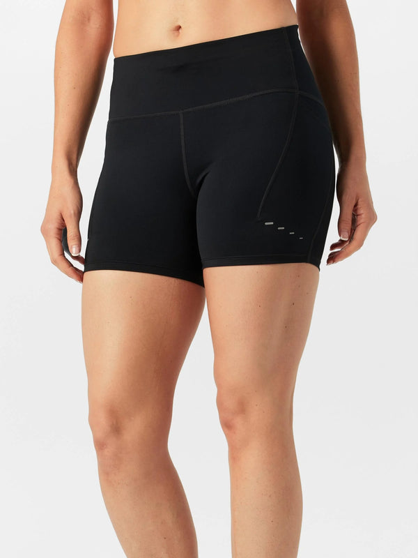 Black athletic shorts worn by a person on a white background