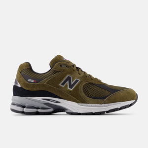 Green running shoe with New Balance logo on a white background