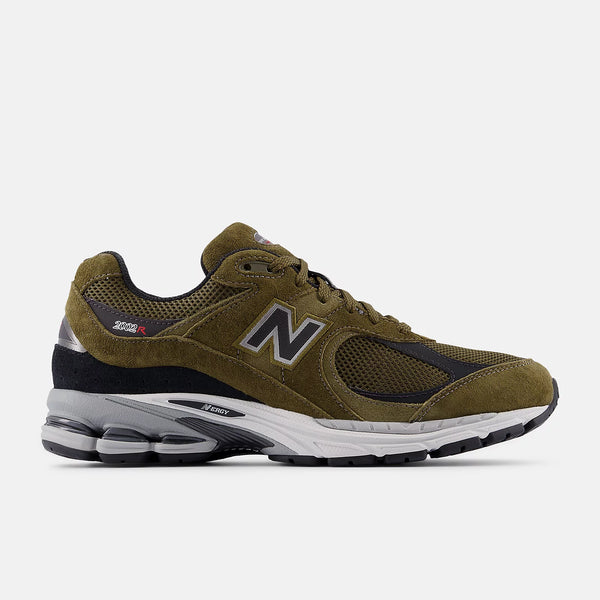 Green running shoe with New Balance logo on a white background