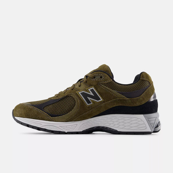 Green running shoe with New Balance logo on a white background
