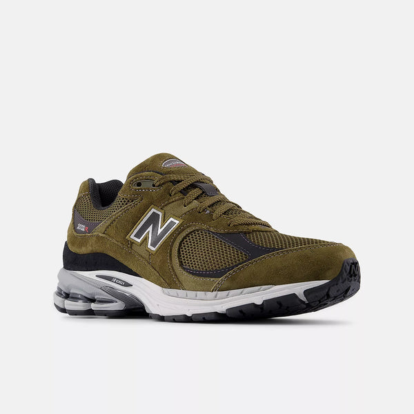 Green running shoe with New Balance logo on a white background