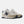 Beige and navy New Balance sneaker on a white background