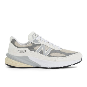 A pair of New Balance running shoes with a primarily white color scheme and gray accents.
