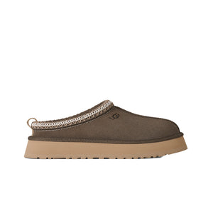 Deep green ugg slipper on a white background