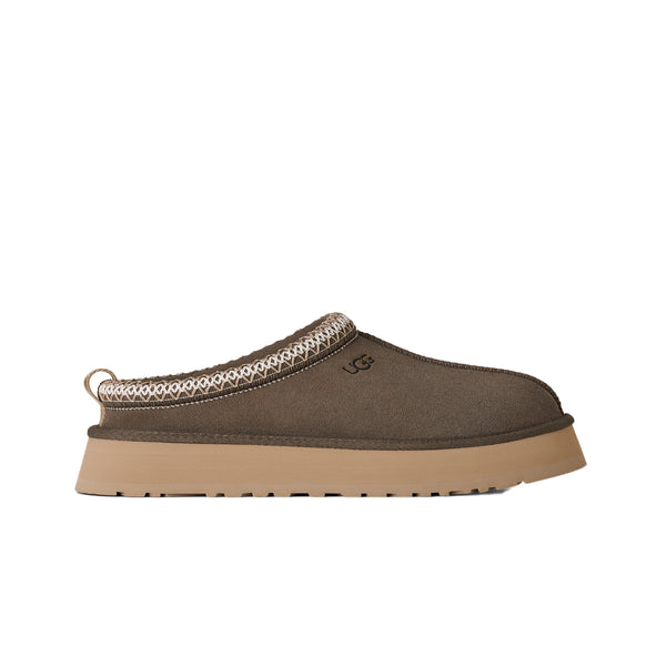 Deep green ugg slipper on a white background