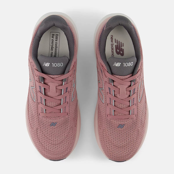 Pair of pink New Balance 1080 sneakers on a white background