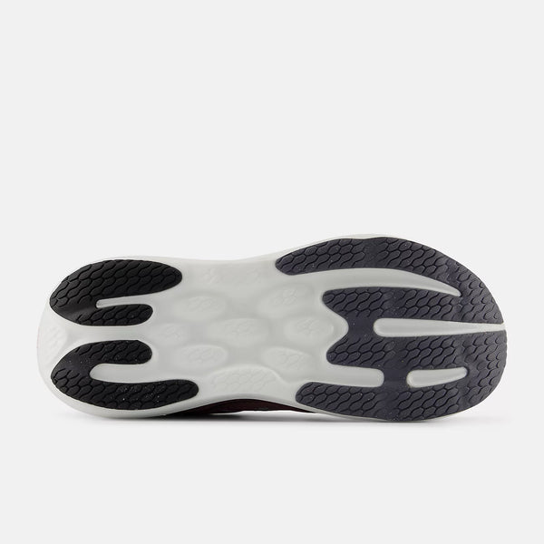 Close-up of a shoe sole with a white and black design on a light gray background