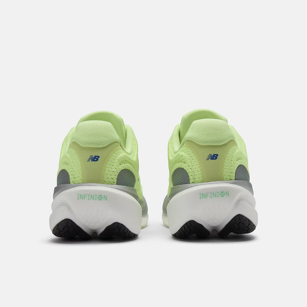 Pair of green running shoes with white soles on a white background