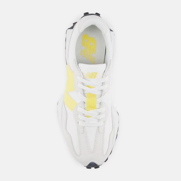White sneaker with yellow accent and yellow New balance logo on a white background.