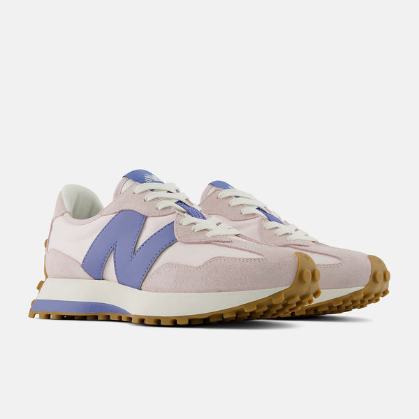 Pair of light pink sneakers with purple accents on a white background