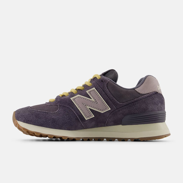 Medial side of a women's 574 sneaker with beige accents on a white background