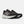 Black running shoes with white soles on a light gray background