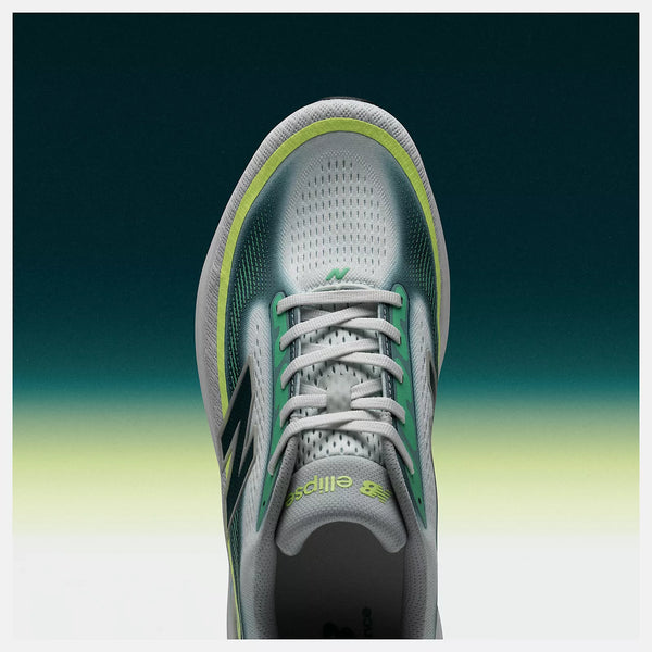 Gray and green athletic shoe on a gradient background