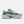 Gray and green running shoe with New Balance logo on a white background