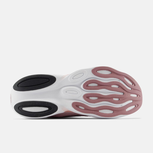 Sole of a shoe with white, black, and pink design on a white background