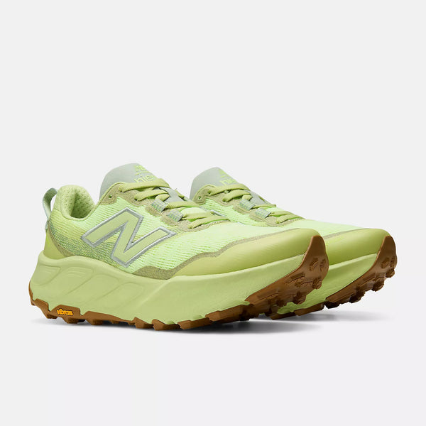 Light green running shoe with brown sole on a white background