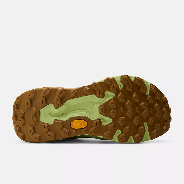 Close-up of a hiking shoe sole with brown and green tread pattern on a white background