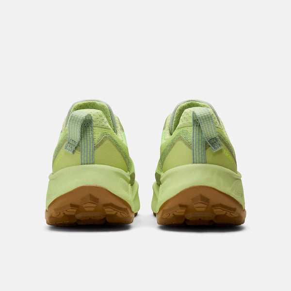 Green sneakers with brown soles on a white background