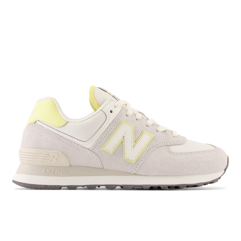 The lateral size of this women's 574 has a big N Logo that is white but has a bit of yellow highlight