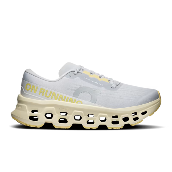 White and grey running shoe with yellow accents on a white background