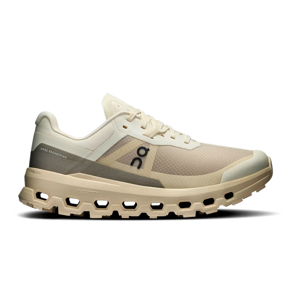 Beige and brown women's trail running shoe with visible brand logo on a white background