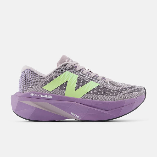 Gray and purple running shoe with green accents on a white background