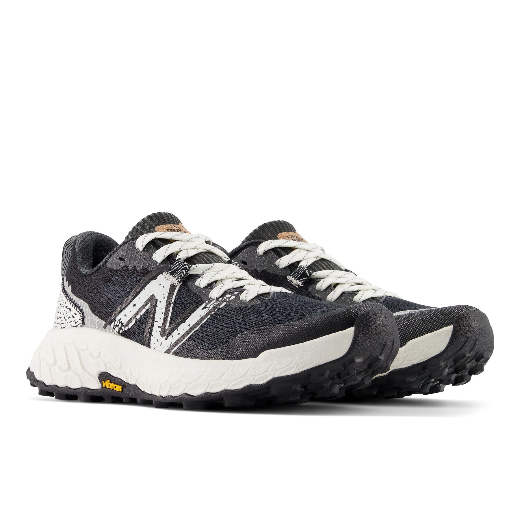 Front angle view of the Women's Hierro V7 trail shoe by New Balance in the color Blactop/Sea Salt