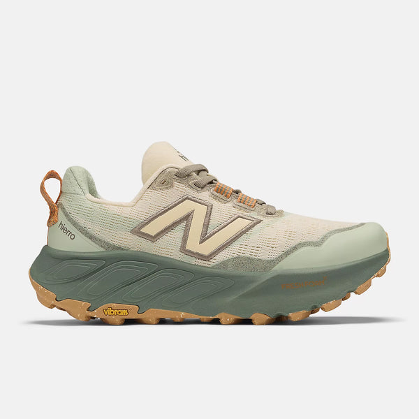 Green and beige running shoe with New Balance logo on a white background
