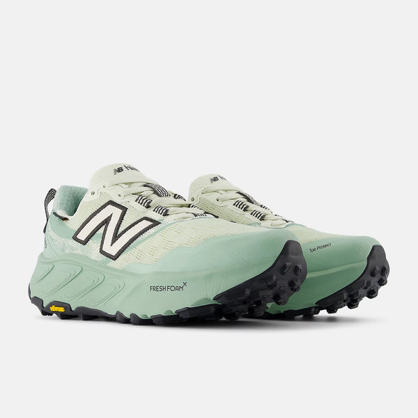 Light green running shoe with black accents on a white background