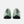 Green hiking shoes with black soles on a white background