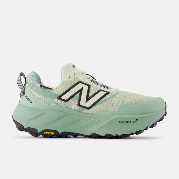 Green running shoe with New Balance logo on a white background